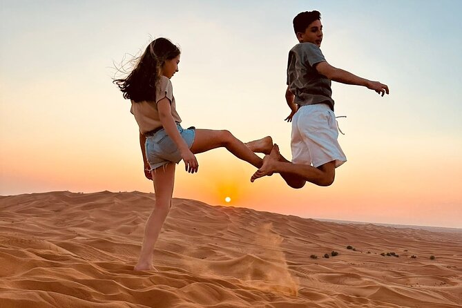 Experience Dubai Best Red Dune Evening Desert Safari BBQ Dinner - Camel Ride and Sand Boarding