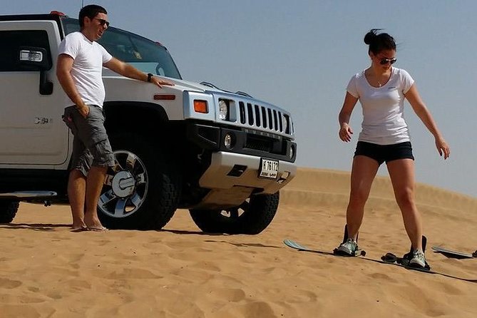 Dubai Desert Morning Tour in 4WD Vehicle: Camel Ride, Quad Bike Tour, Sandboarding, and Camel Farm - Sandboarding Down the Dunes