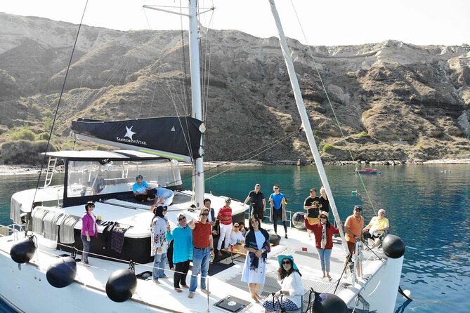 Half-Day Exclusive Catamaran Cruise in Santorini With Meal and Open Bar - Traveler Capacity