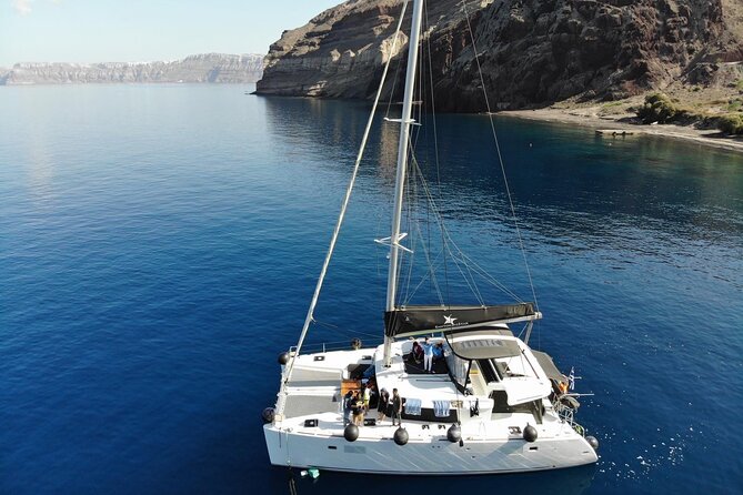Half-Day Exclusive Catamaran Cruise in Santorini With Meal and Open Bar - Overview and Highlights
