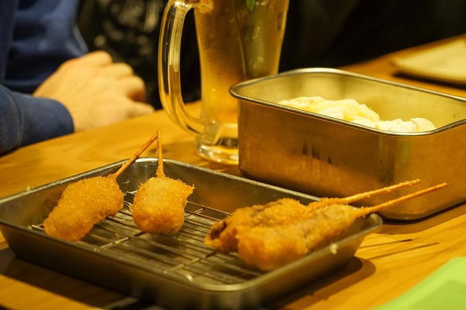 Osaka Local Foodie Walking Tour in Dotonbori and Shinsekai - Exploring Osakas Iconic Neighborhoods