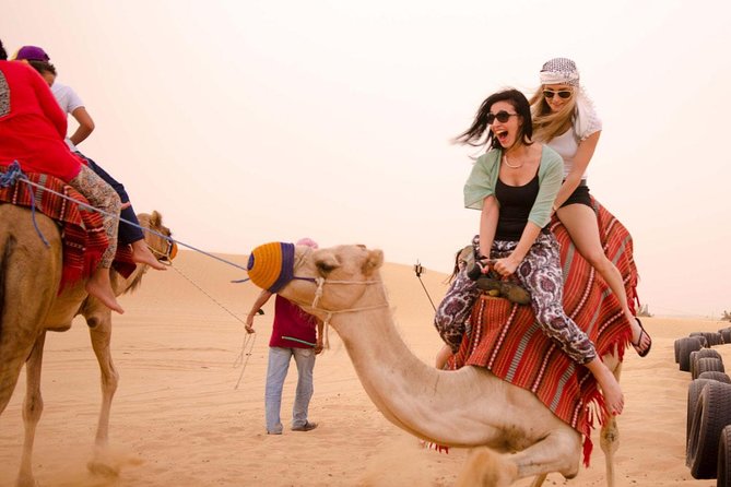 Dubai Desert Safari With BBQ Dinner, Dune Bashing & Live Show - Camel Riding and Sandboarding Fun