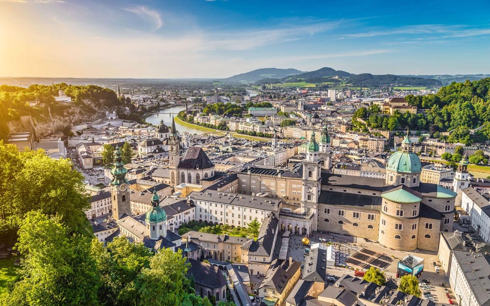 From Vienna: Day Tour to Hallstatt and Salzburg & Boat Ride - Historic Exploration of Salzburg