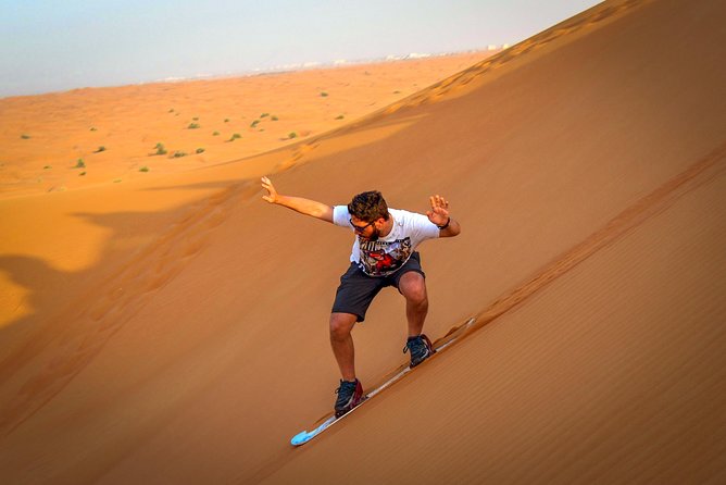 Evening Red Dunes Desert Safari Dubai With Sanboarding Camel Ride & BBQ